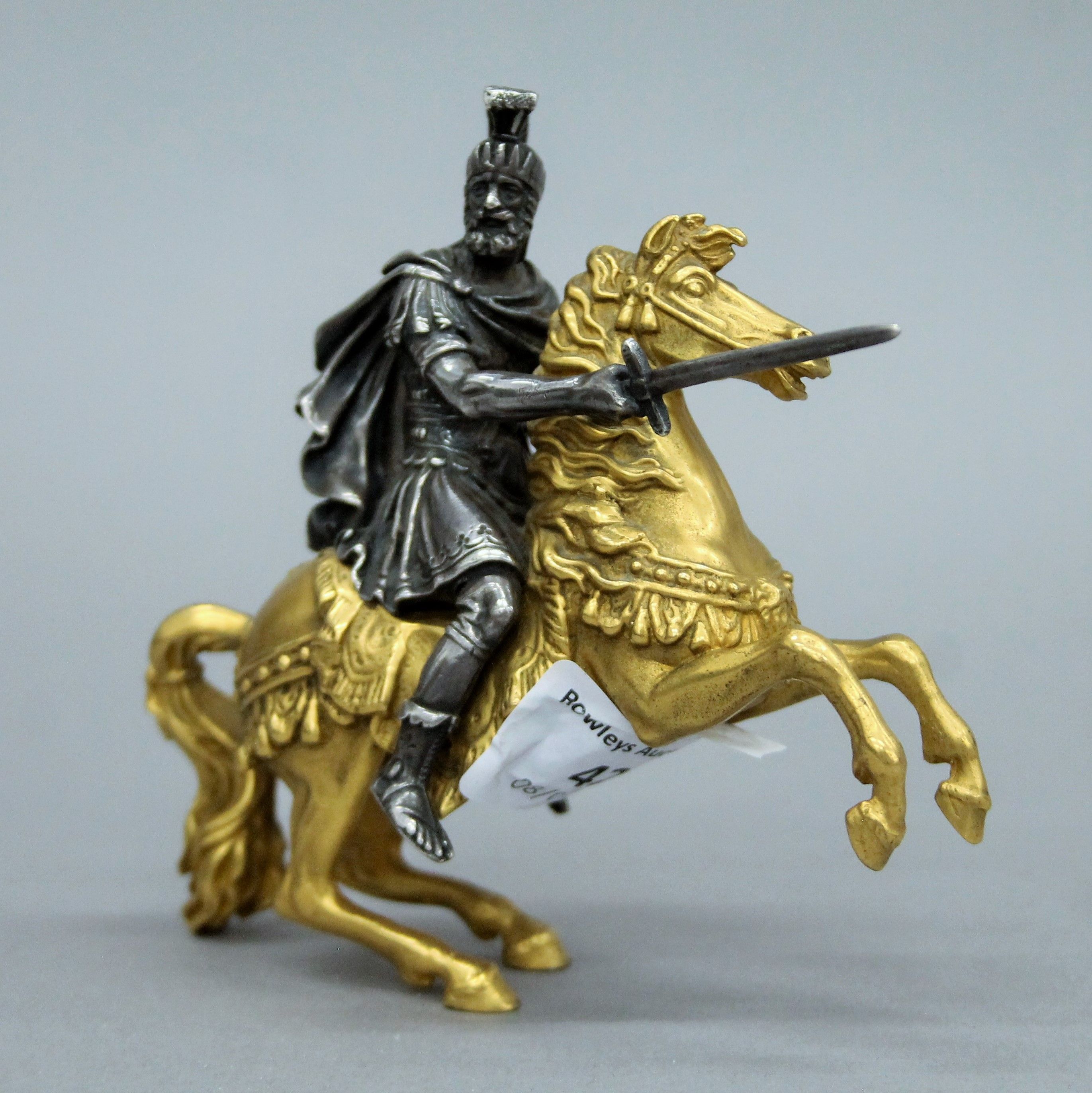 A 19th century gilt and silvered bronze model of a warrior on horseback. 11 cm high.