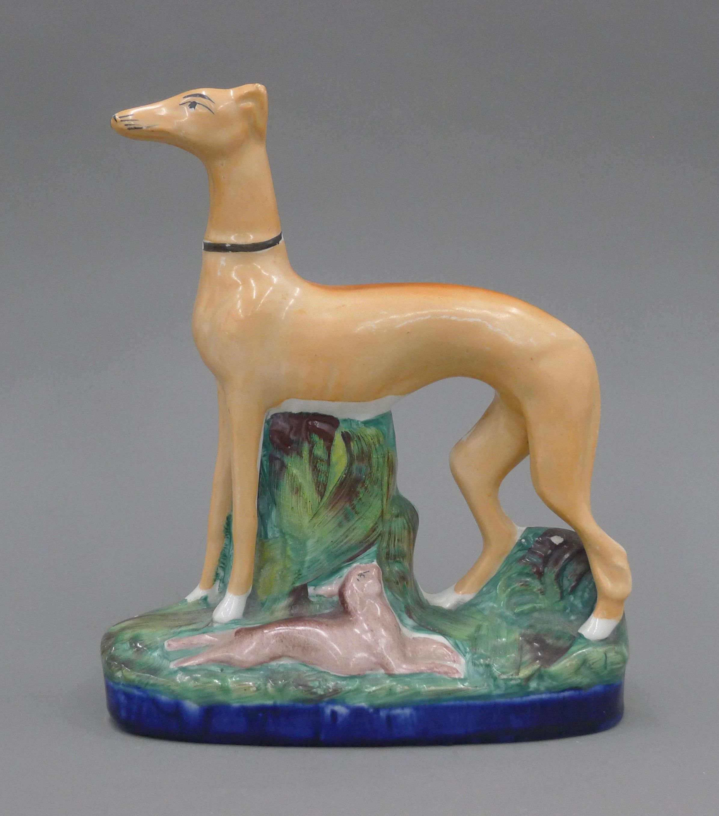 A 19th century Staffordshire pottery model of a coursing greyhound and hare,