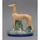 A 19th century Staffordshire pottery model of a coursing greyhound and hare,