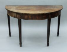 A 19th century mahogany demi lune table. 122 cm wide.