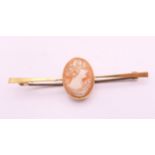 A 9 ct gold cameo bar brooch. 5.5 cm long. 2.9 grammes total weight.