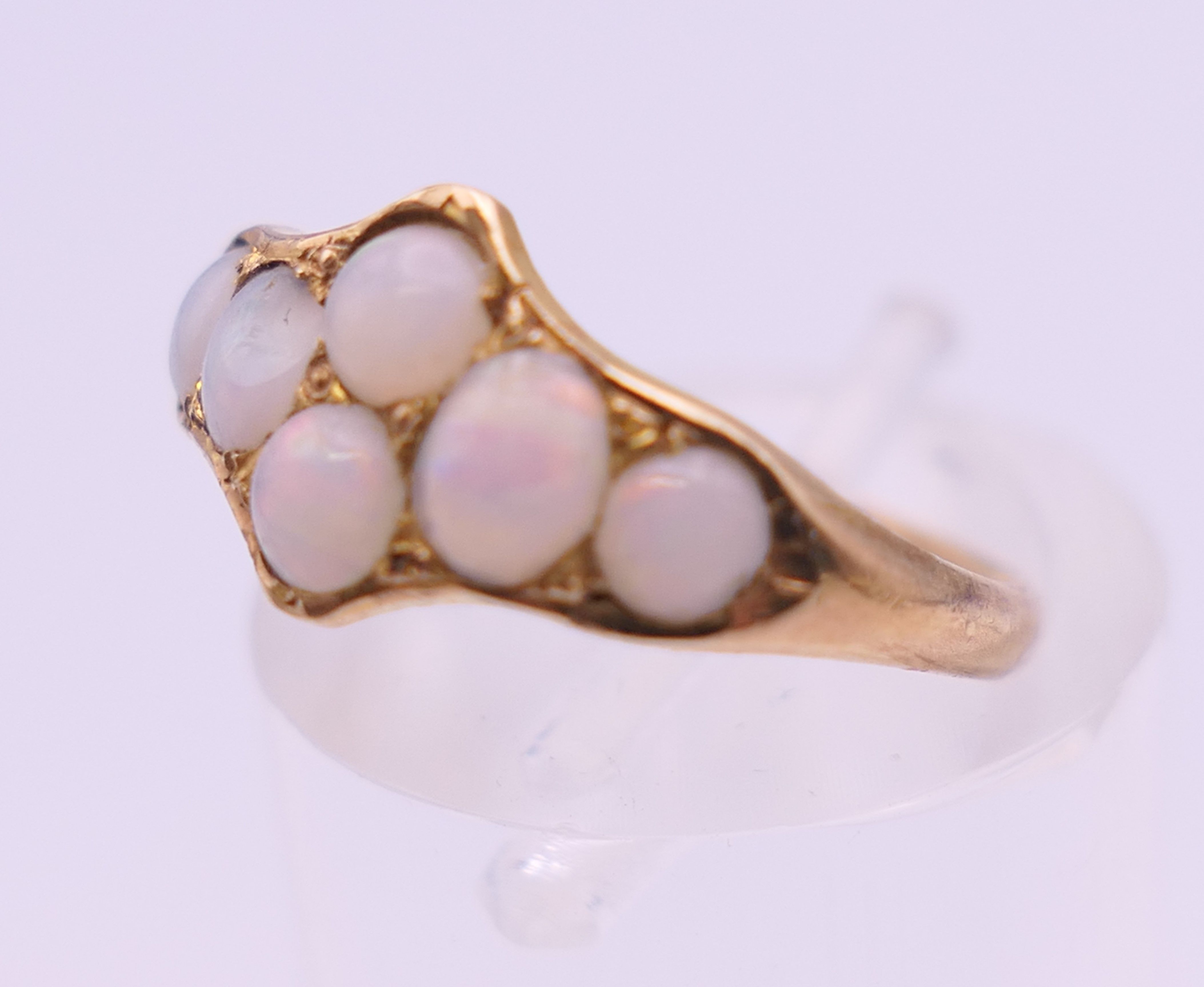 An unmarked gold opal set ring. Ring size K/L. 1.5 grammes total weight. - Image 4 of 5