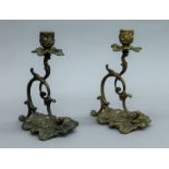 A pair of rococo style bronze candlesticks. 20 cm high.