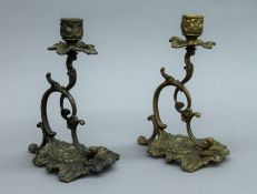 A pair of rococo style bronze candlesticks. 20 cm high.