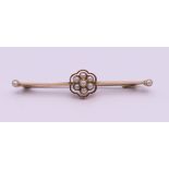 A 15 ct gold seed pearl set bar brooch. 4.5 cm long. 3 grammes total weight.