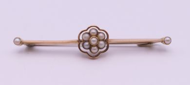 A 15 ct gold seed pearl set bar brooch. 4.5 cm long. 3 grammes total weight.
