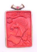 A Tibetan cinnabar horse pendant. 9.5 cm high.
