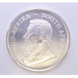 A 1 ounce fine silver krugerrand coin.
