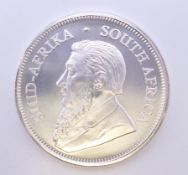 A 1 ounce fine silver krugerrand coin.