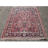 A Persian red ground rug. 127 x 190 cm.