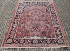 A Persian red ground rug. 127 x 190 cm.