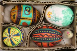 A quantity of German painted Easter eggs. The largest 6 cms high.