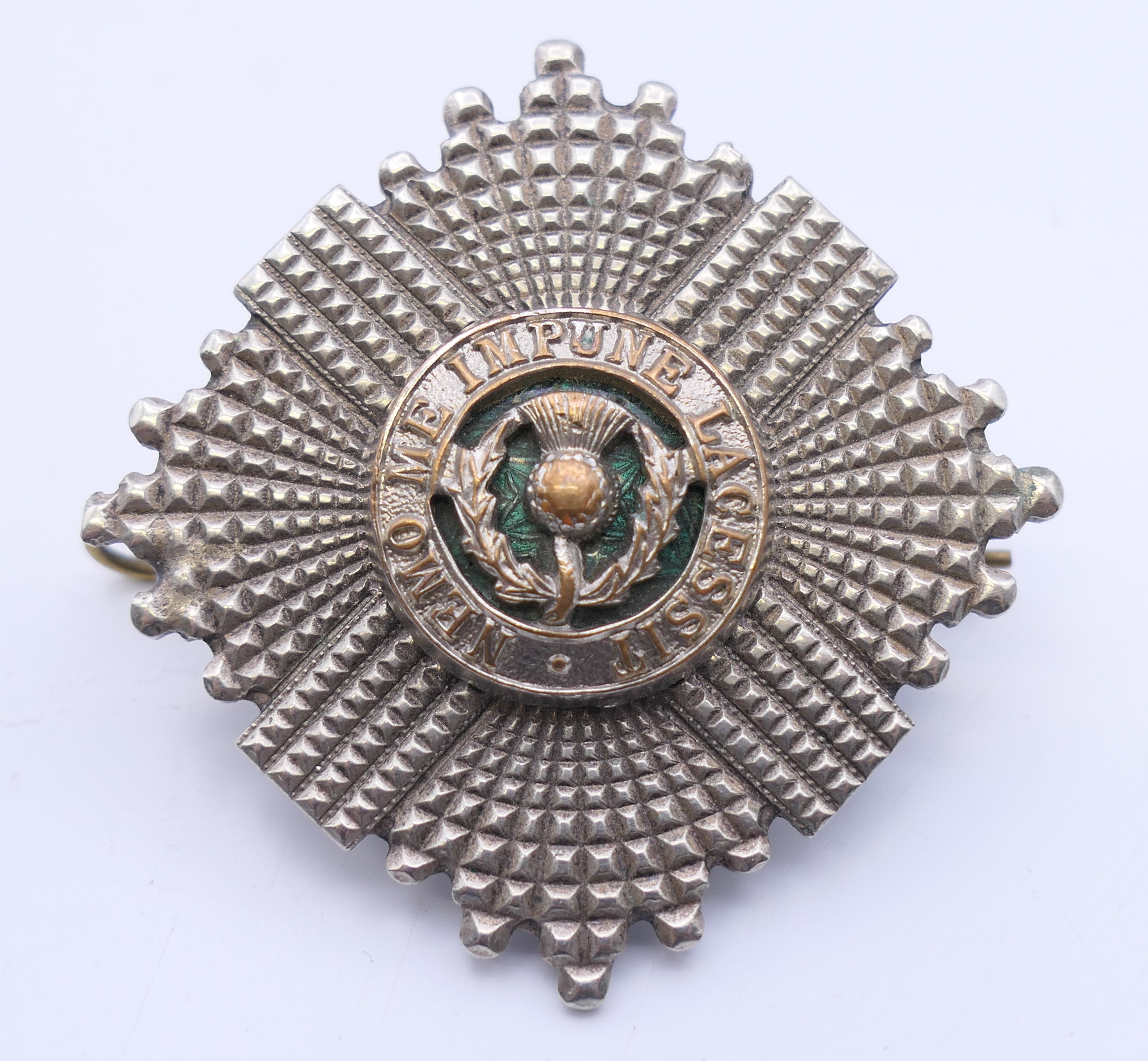 A military cap badge. 5 cm diameter.