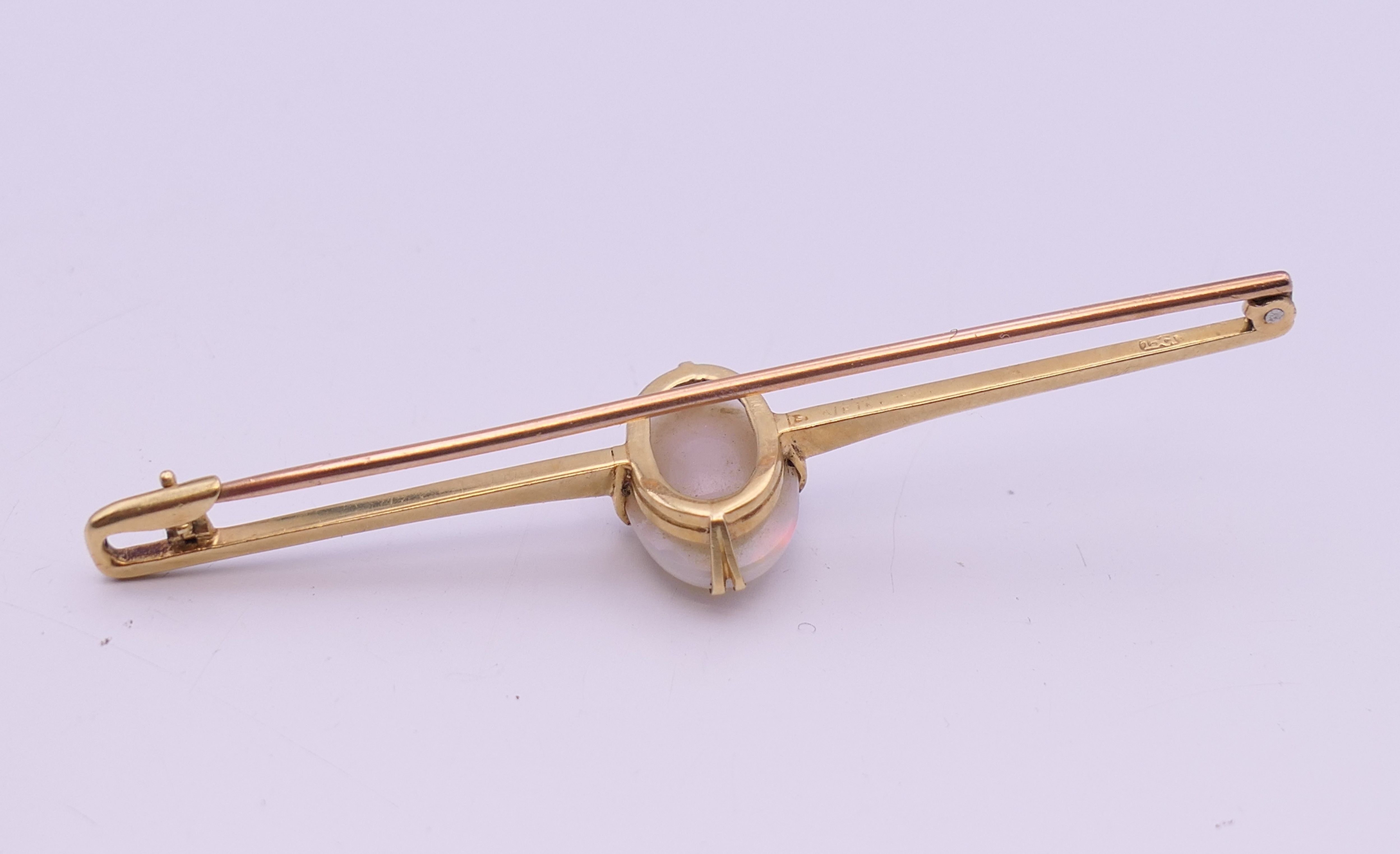 A 15 ct gold opal set bar brooch. 7 cm long, opal 1.5 cm high. 5.3 grammes total weight. - Image 4 of 9