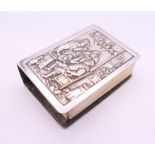 A Continental silver matchbox holder, the front decorated with a tavern scene. 5.5 x 4 x 1.75 cm.