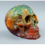 A model of a skull. 13 cm high.