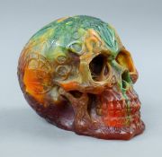 A model of a skull. 13 cm high.
