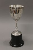 A silver plated trophy on stand. 31 cms high.