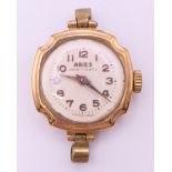 An Aries 9 ct gold cased lady's wristwatch. 2 cm diameter. 9.1 grammes total weight.
