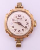 An Aries 9 ct gold cased lady's wristwatch. 2 cm diameter. 9.1 grammes total weight.
