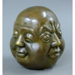 A brass four face Buddha. 10 cm high.