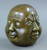 A brass four face Buddha. 10 cm high.