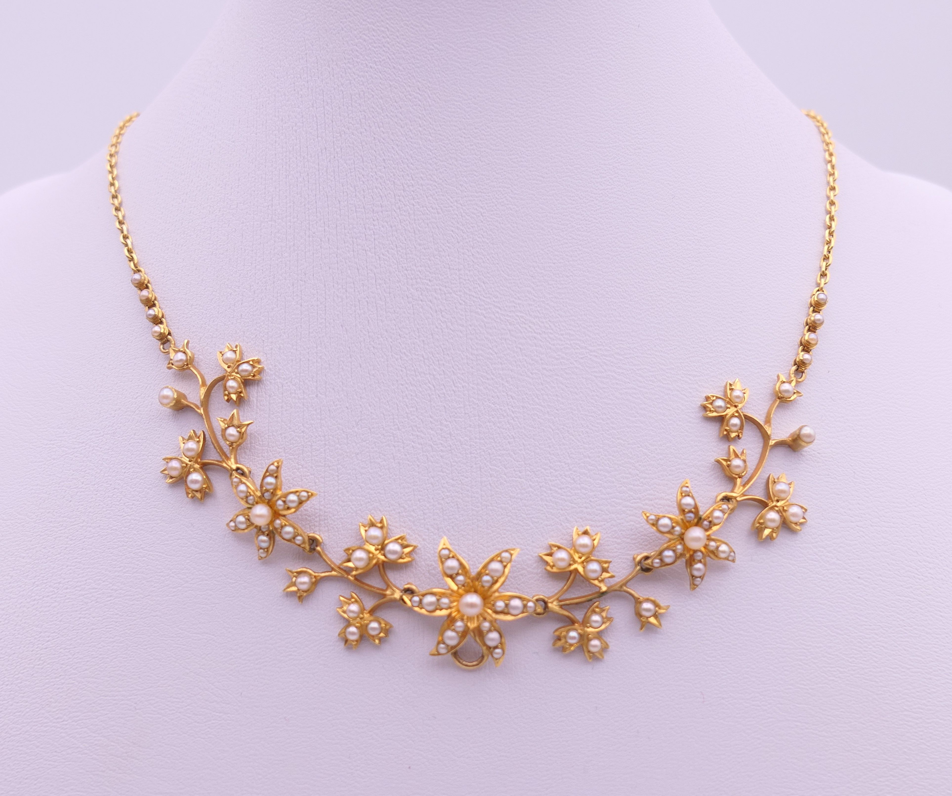 An unmarked gold seed pearl set necklace of scrolling floral form and detachable pendant formed as - Image 3 of 16