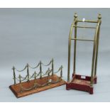 A Victorian brass and iron stick stand, and a bottle rack. The former 22 cm wide.