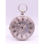 A silver open face pocket watch. 4 cm diameter.