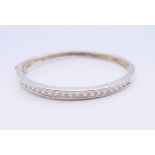 A silver stone set bracelet. 5.75 cm internal diameter.