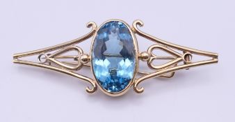 A large 9 ct gold blue stone (possibly aquamarine) brooch, circa 1900. 8 cm long, 3 cm high. 24.