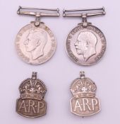 A WWI 1914-1918 silver medal, a 1939-45 Defence medal awarded to A-311743 A SJT A A WILSON ASC,