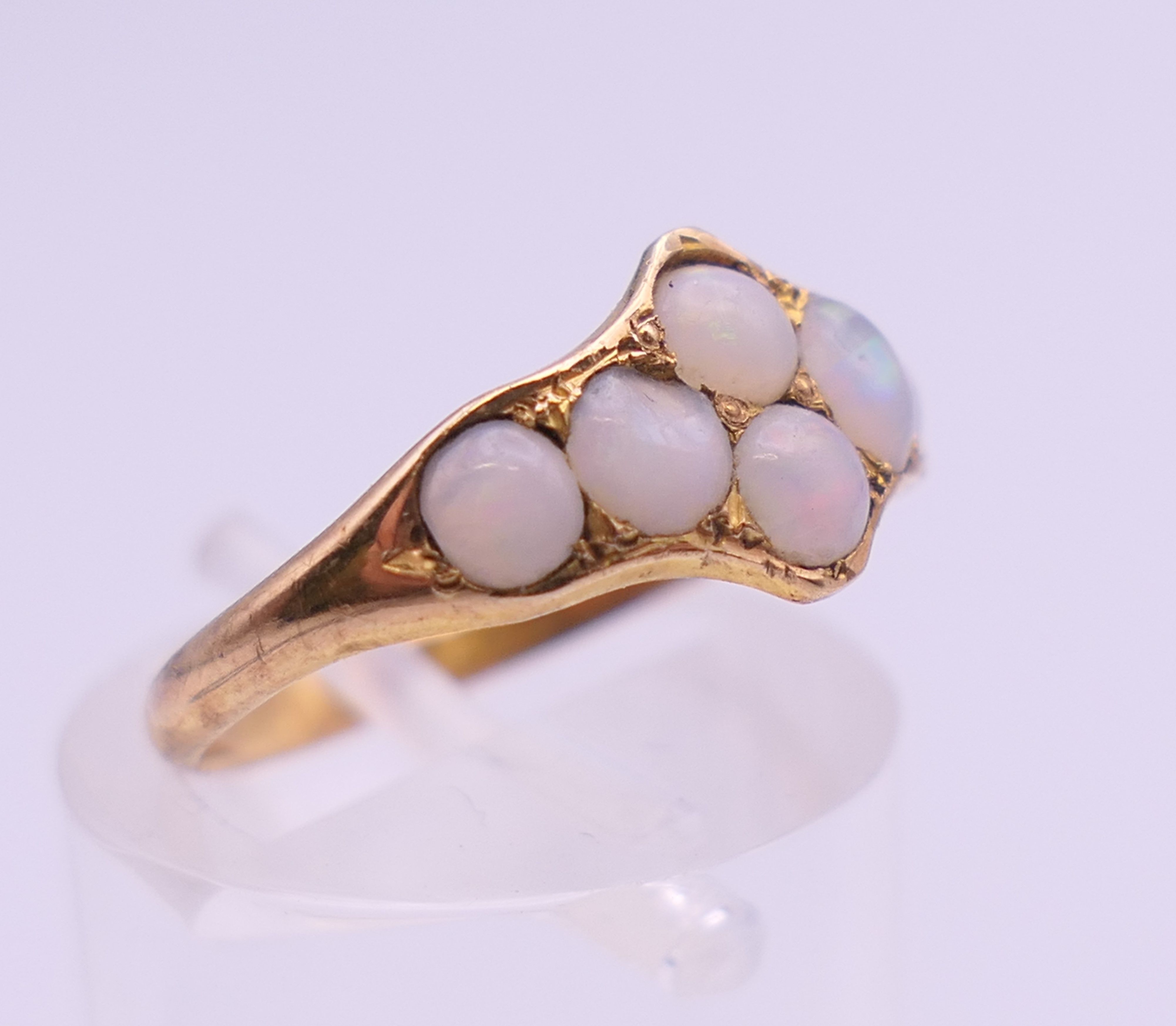 An unmarked gold opal set ring. Ring size K/L. 1.5 grammes total weight. - Image 3 of 5