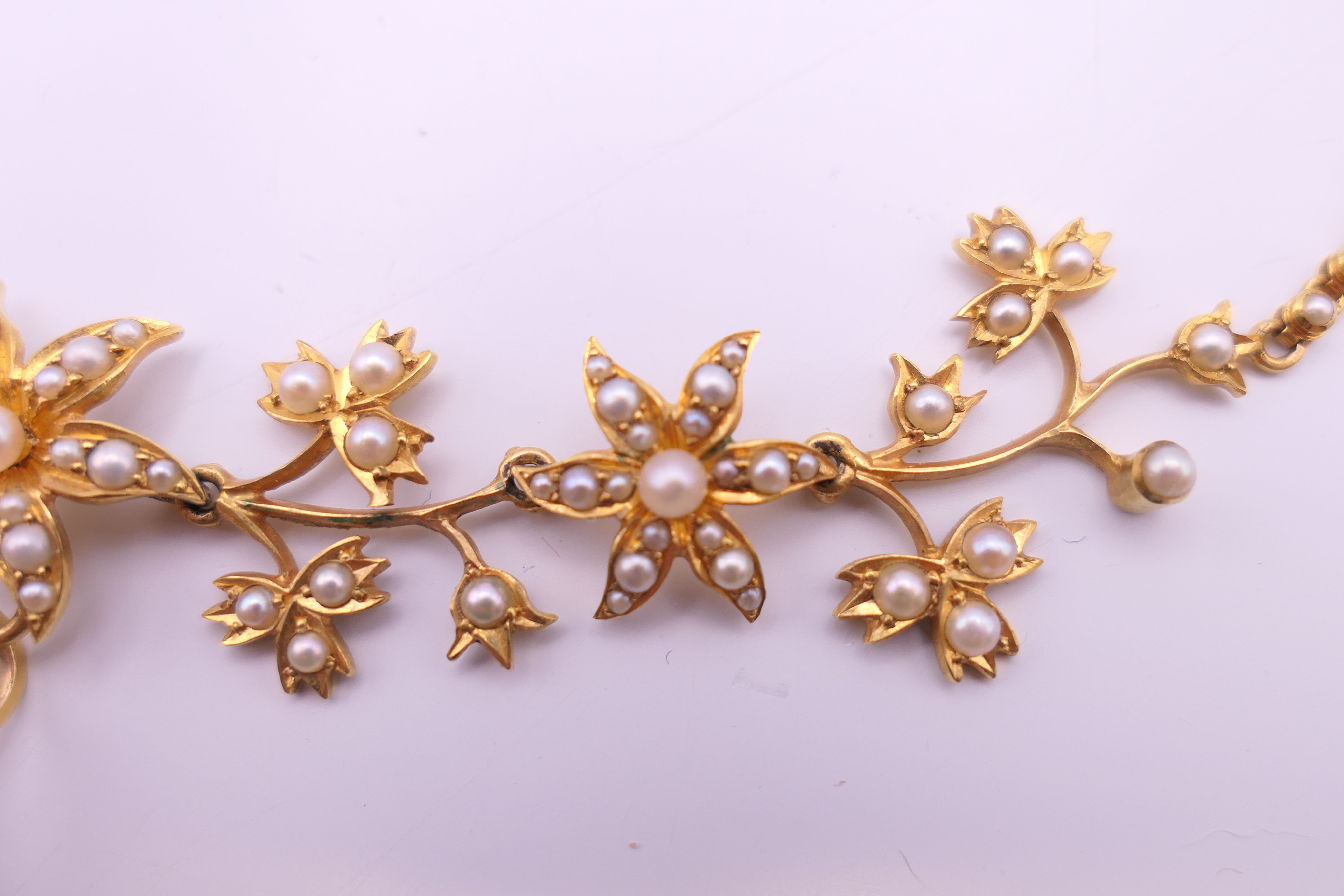 An unmarked gold seed pearl set necklace of scrolling floral form and detachable pendant formed as - Image 8 of 16