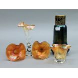 An iridescent glass vase, three epergne flutes and a vase. The former 19 cm high.