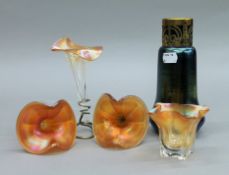 An iridescent glass vase, three epergne flutes and a vase. The former 19 cm high.