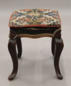 A Victorian rosewood framed stool with tapestry covered seat. 35 cm wide, 44 cm high.