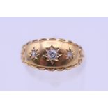 A Victorian 18 ct gold three stone diamond gypsy set ring. Ring size N. 2 grammes total weight.