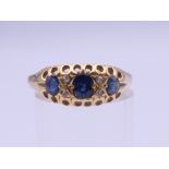 An 18 ct gold sapphire and diamond ring. Ring size P/Q. 3.5 grammes total weight.