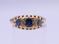 An 18 ct gold sapphire and diamond ring. Ring size P/Q. 3.5 grammes total weight.