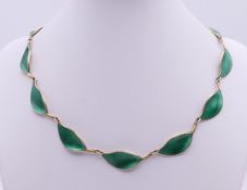 A David Andersen green enamel and silver leaf form necklace. 40 cm long.