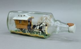 A model of a gypsy caravan in a bottle. 35 cm long.