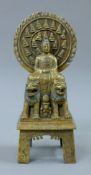 A bronze model of Buddha seated above two dogs-of-fo. 27 cm high.