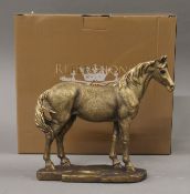 A boxed bronzed model of a horse. 16 cms high.