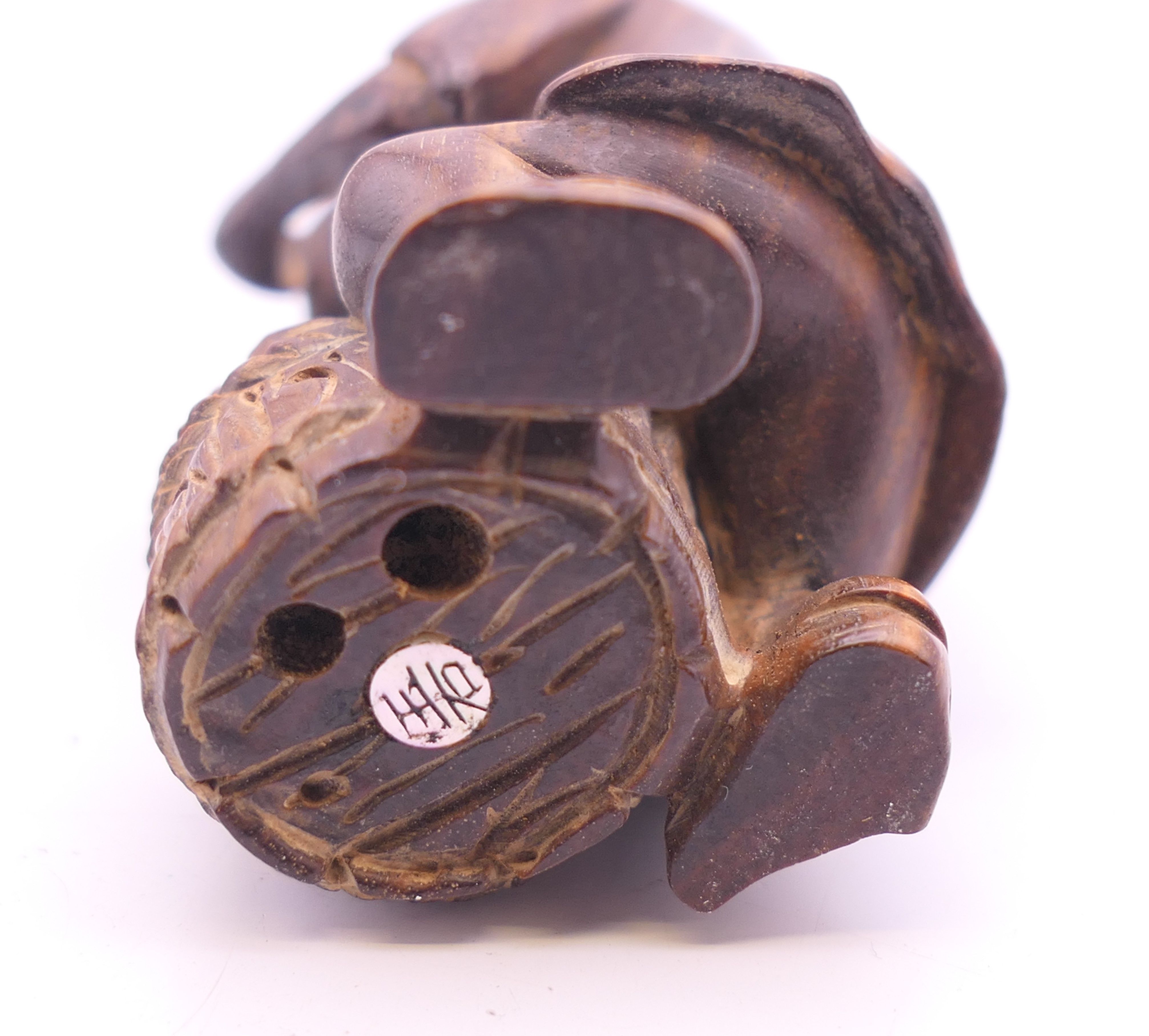 A netsuke formed as a man with a barrel. 6 cm high. - Image 4 of 4