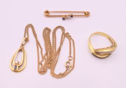 An 18 ct gold diamond and sapphire ring, a pendant necklace on chain and a 15 ct gold bar brooch.