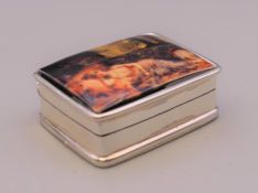 A silver pill box, the lid depicting a reclining nude. 3 cm wide.