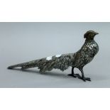 A vintage silver plated model of a pheasant with glass eyes. 27 cms long.