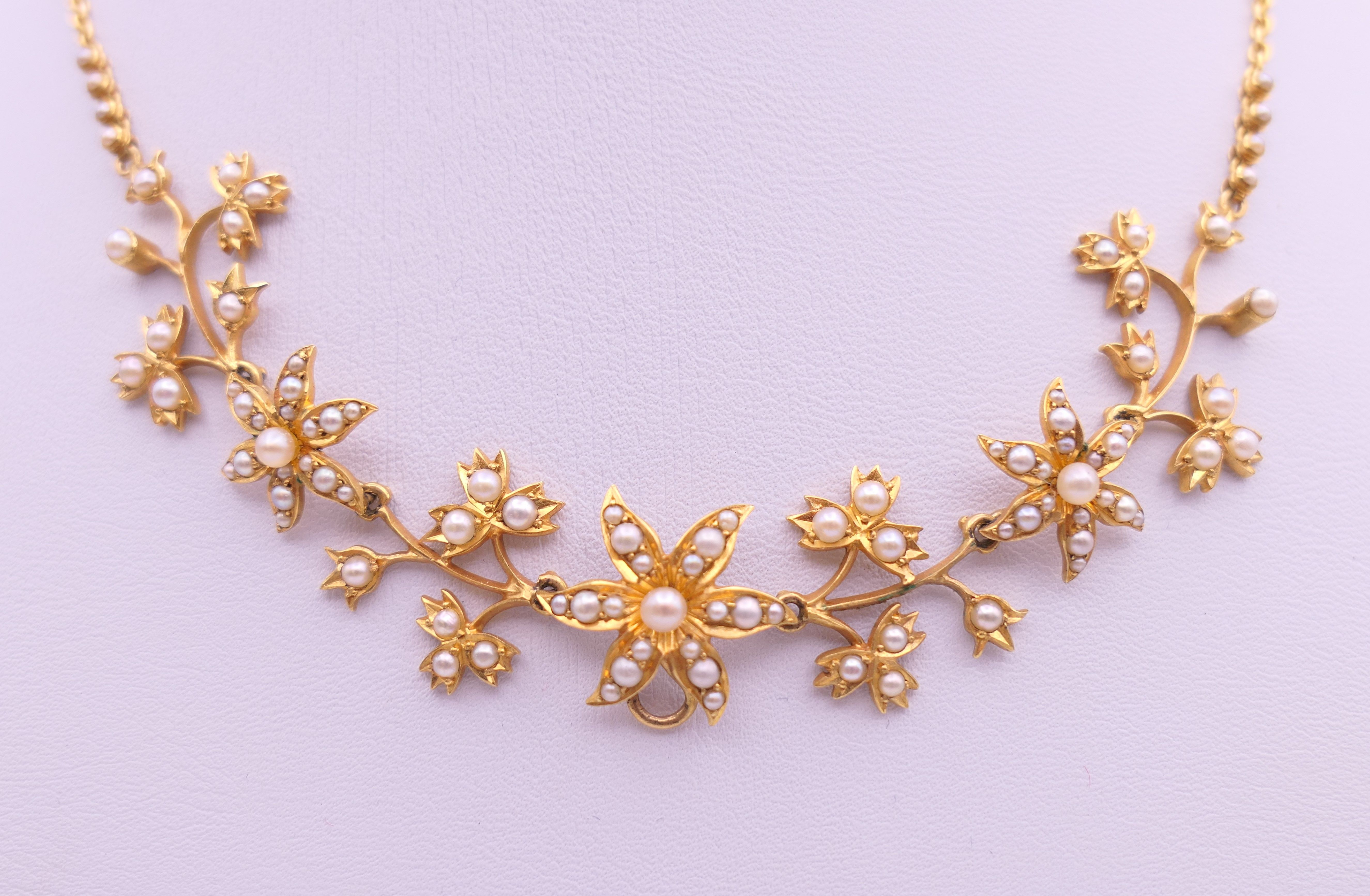 An unmarked gold seed pearl set necklace of scrolling floral form and detachable pendant formed as - Image 4 of 16