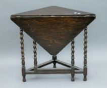 An early 20th century oak barley twist drop leaf table. 82 cm wide.